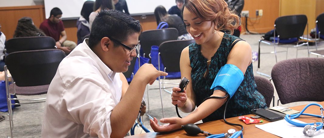 Bridge to Future students learning how to take blood pressure reading